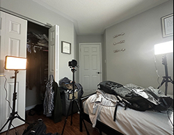 A picture of a camera and lighting setup in a bedroom used as setuo practice for the interview